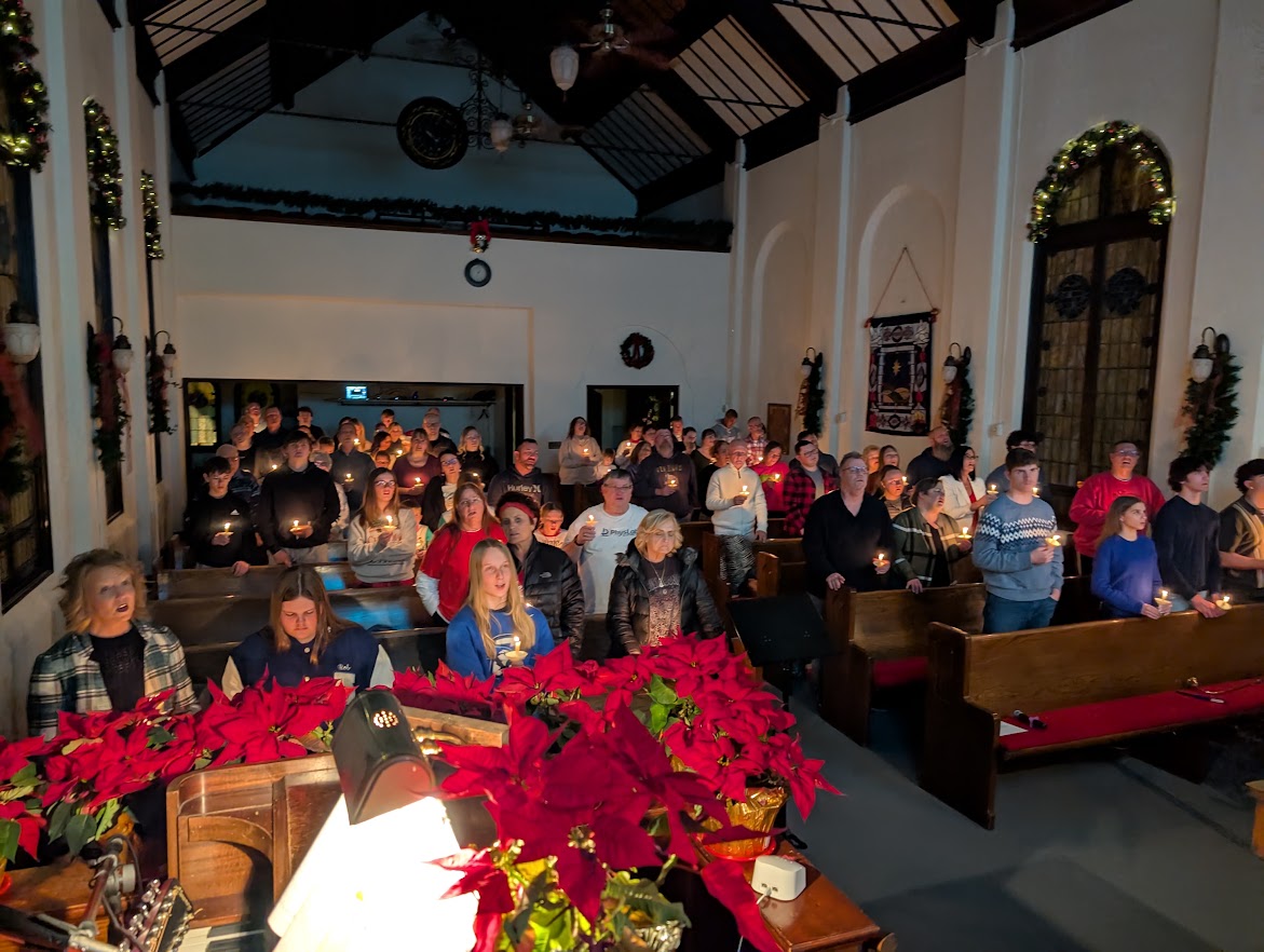 FCC Ashland congregation worshiping together by candlelight